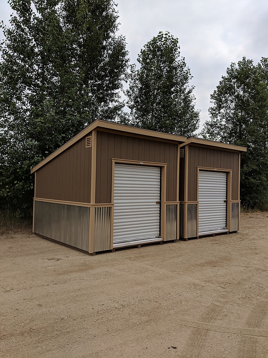 Colorado garage buildings with wide vehicle door openings on a prepared gravel site