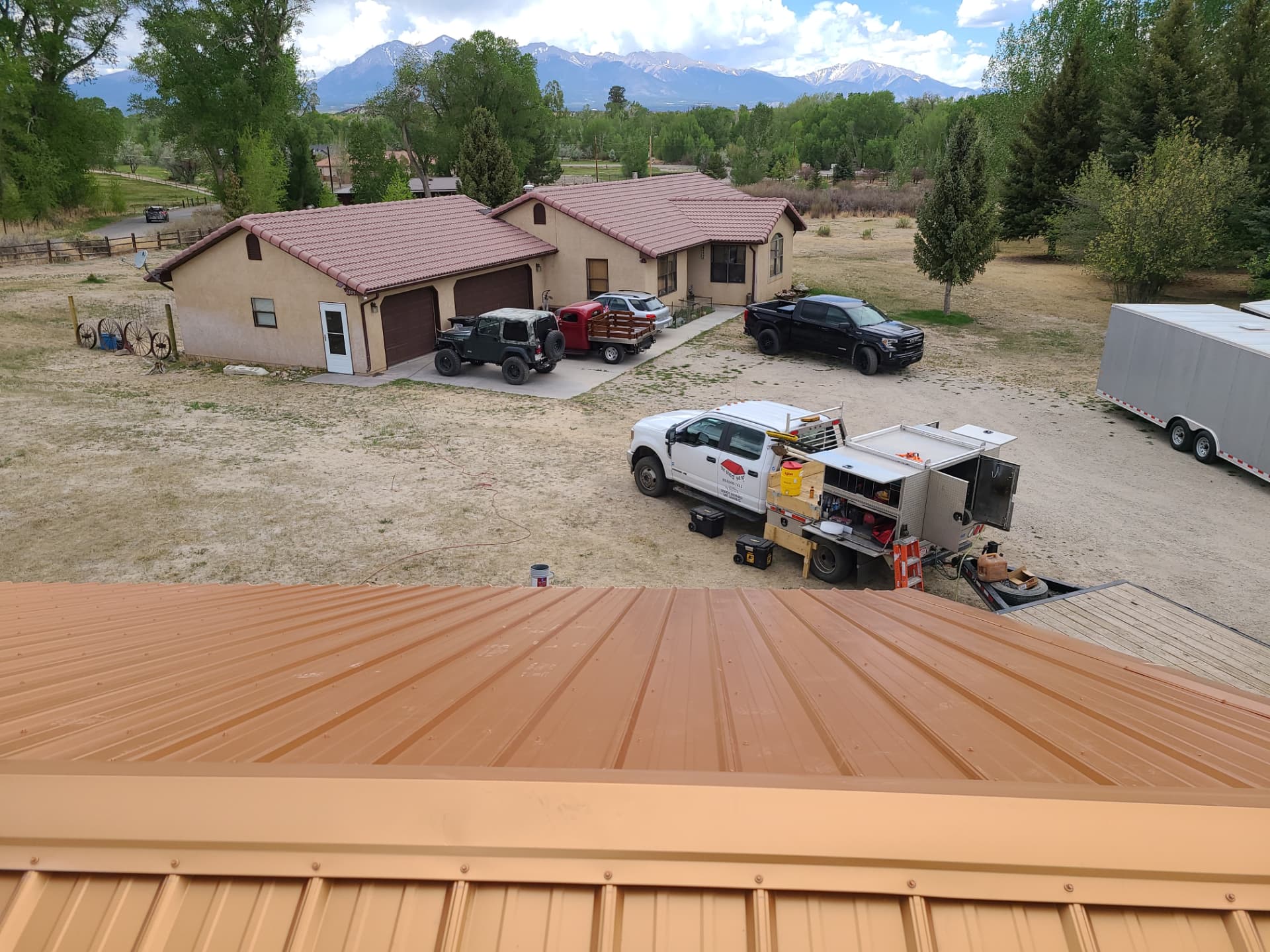 Rural Colorado property with mountain views where a detached garage build crew is set up on site