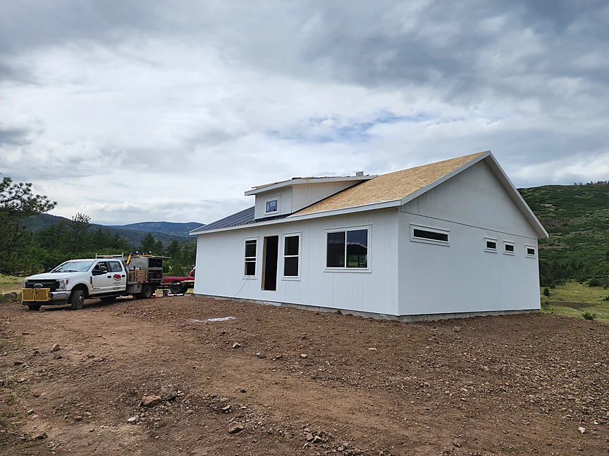 Finished white Sunny Side home shell on a Colorado build site