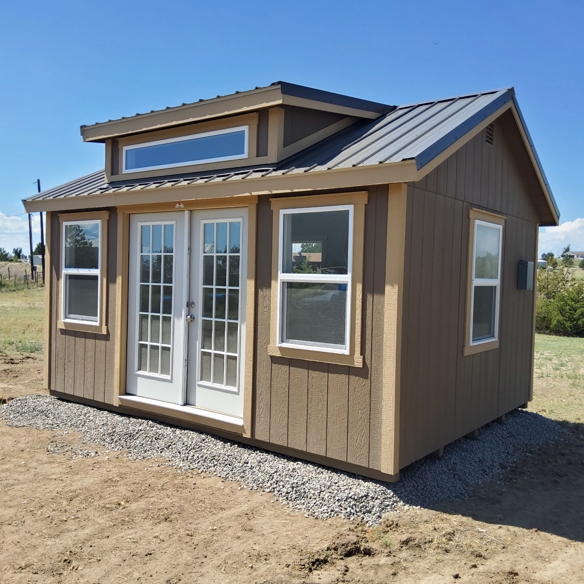 Finished 12x16 shed home office exterior with French doors and dormer windows
