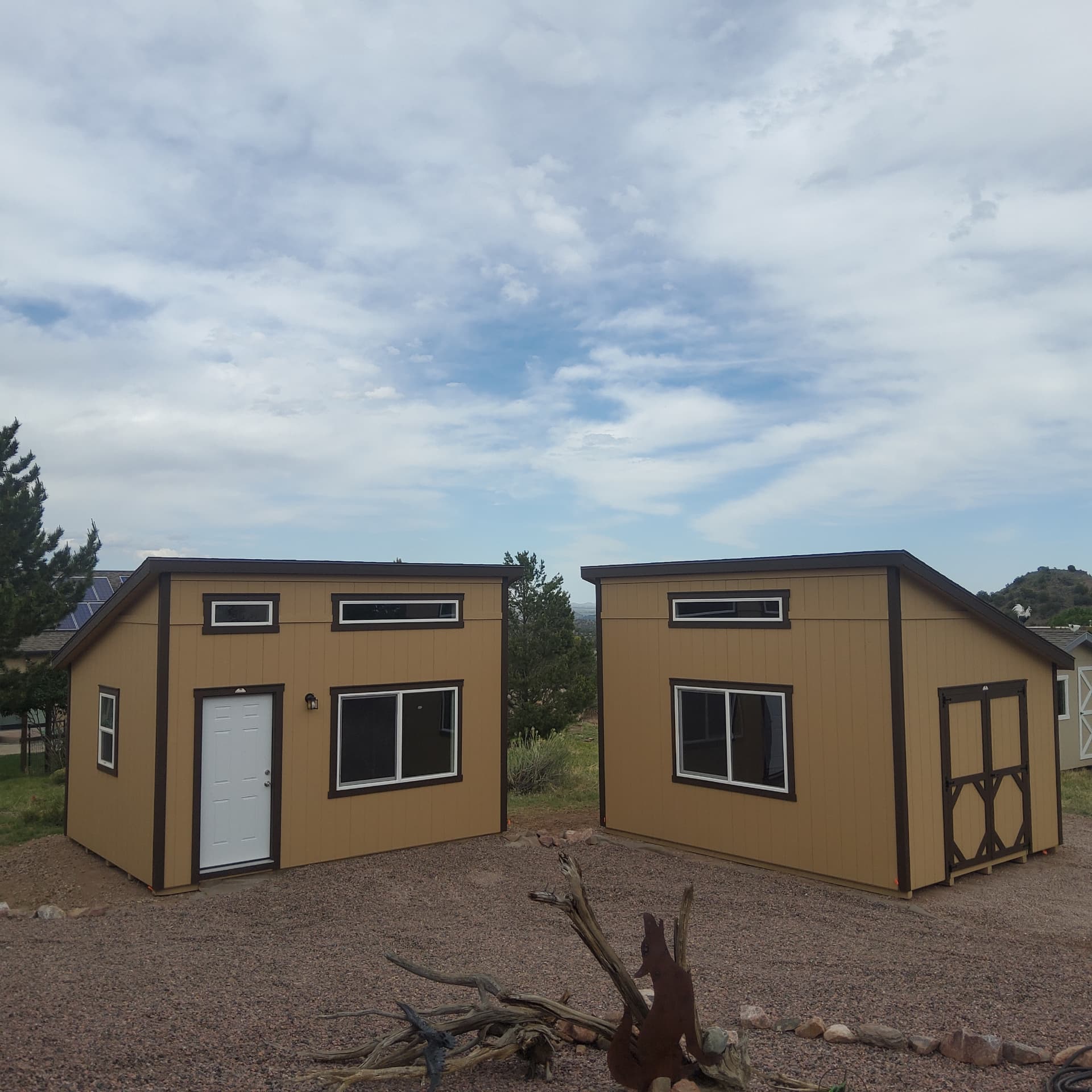 Two studio sheds delivered in Colorado, one used as a home gym and one for storage