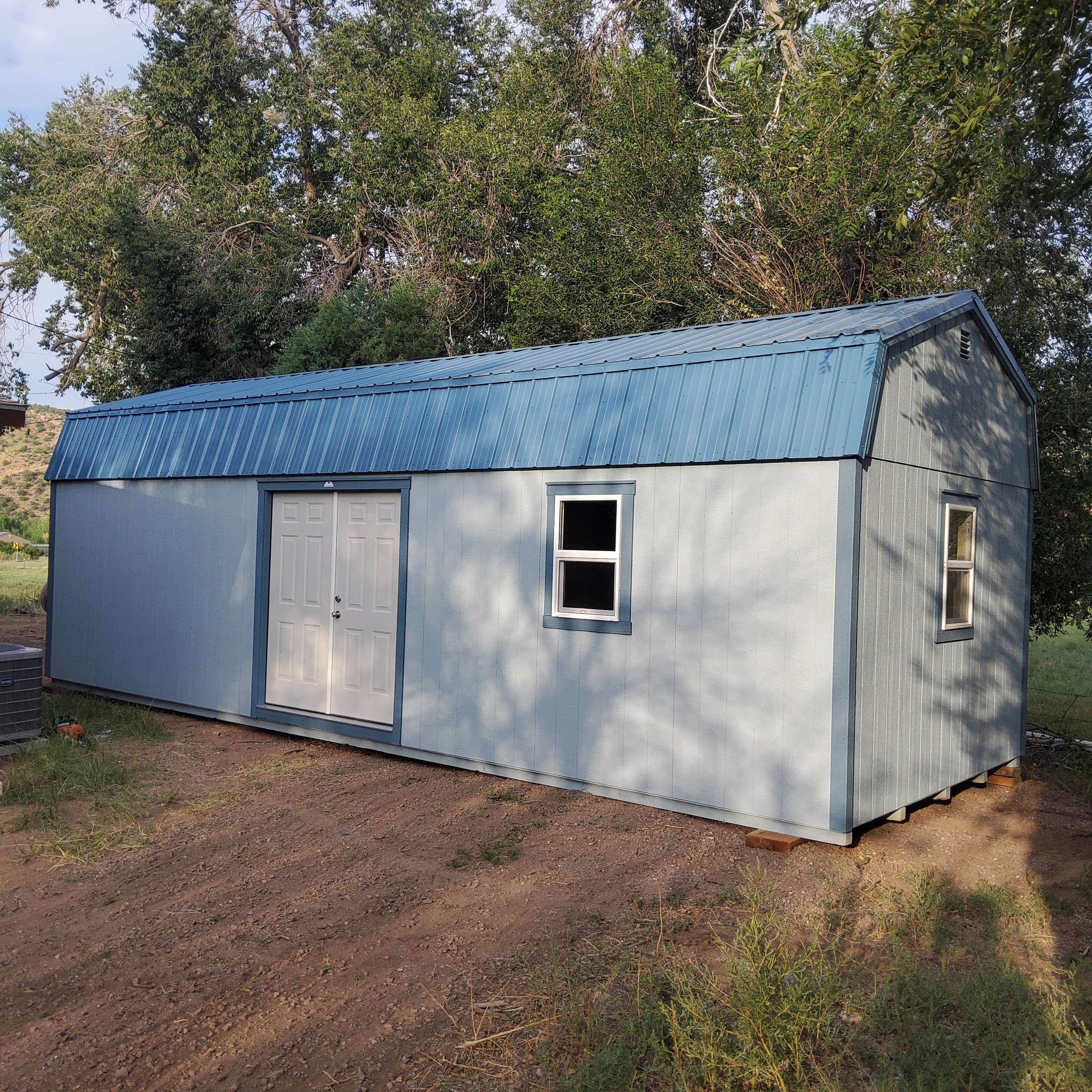 Hi-Wall Mini Barn delivered fully assembled to a Colorado property with gambrel roof and loft storage