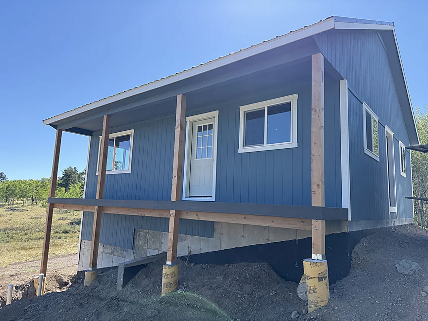 Blue Sunny Side shell with full-length covered porch
