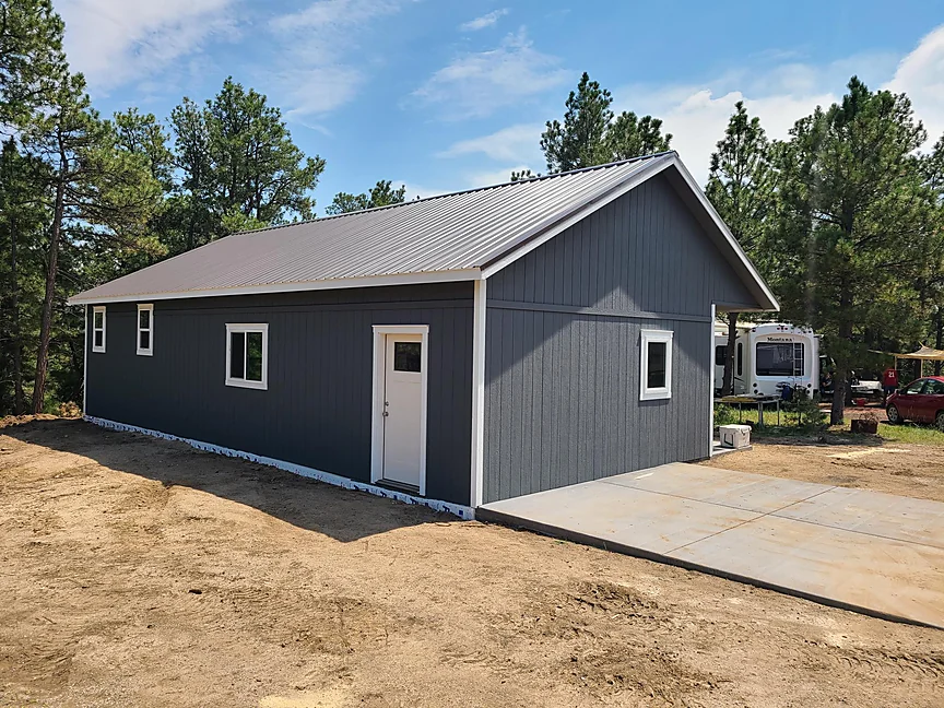 Dark gray Cabin shell on a finished concrete pad