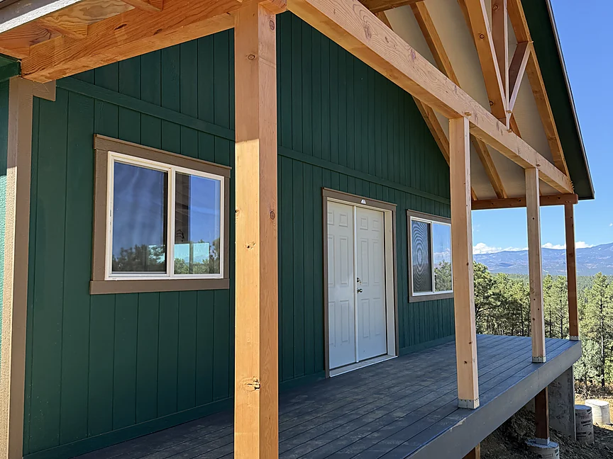 Dark green Sunny Side shell with timber-frame porch
