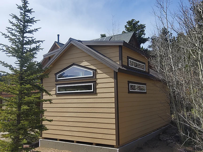 Tan Cabin shell with arched dormer windows