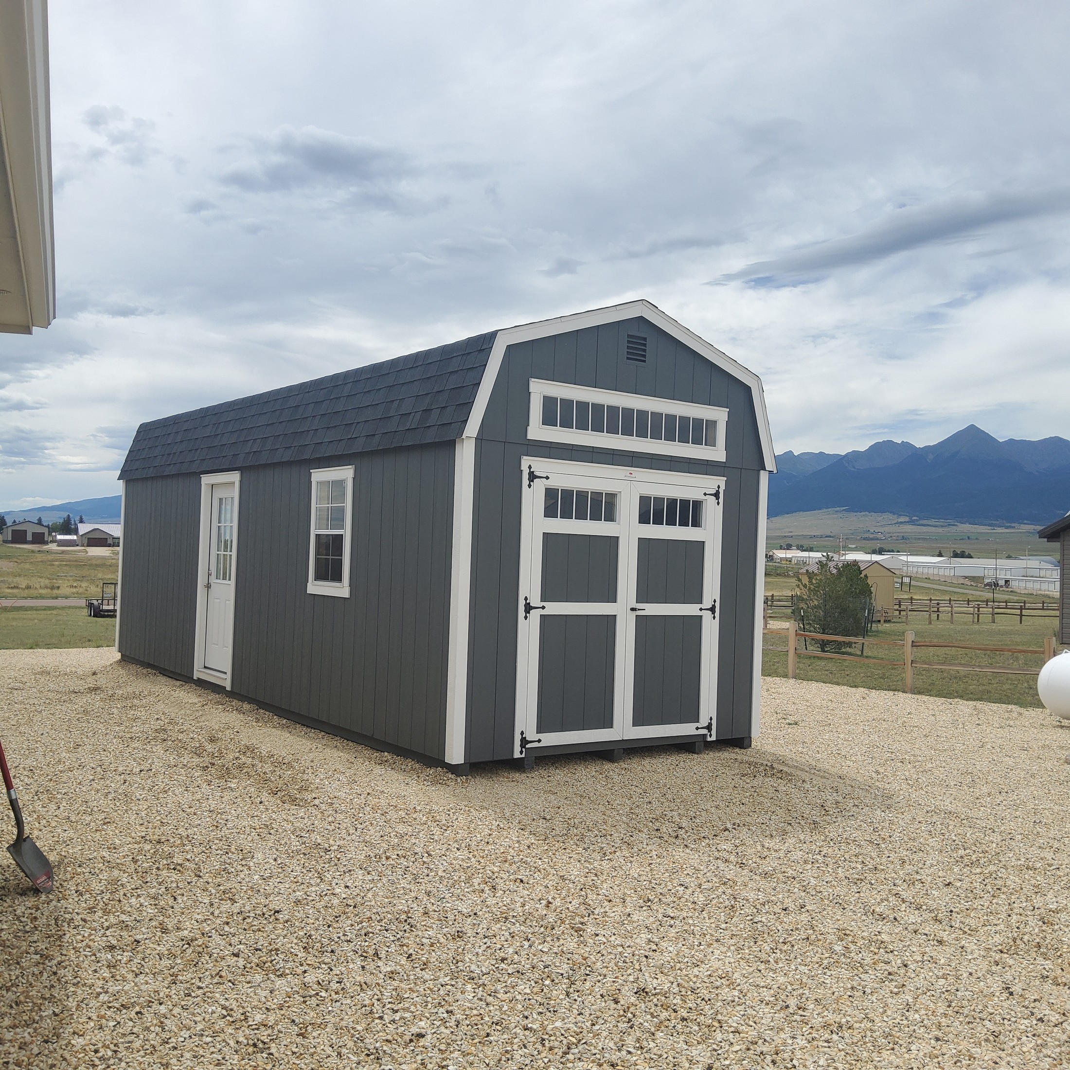 Barn delivered fully assembled to a Colorado backyard by The Shed Yard delivery truck