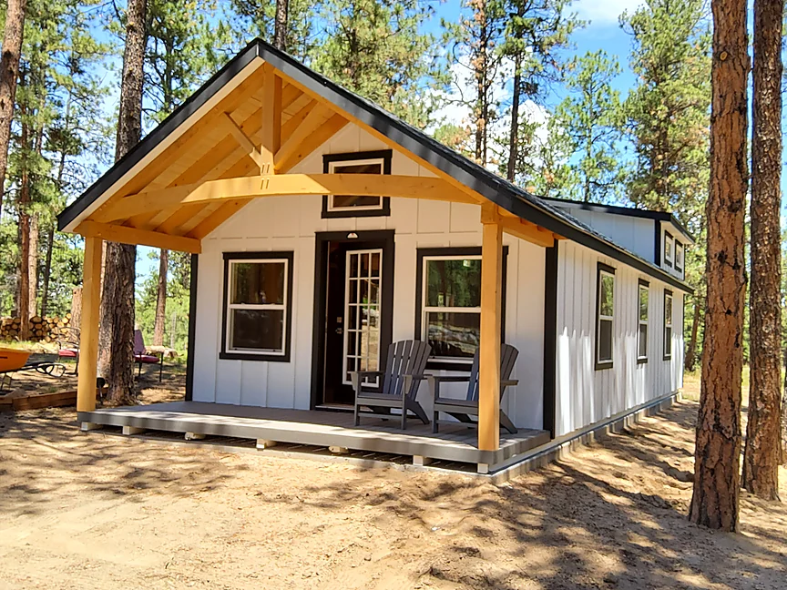 White Cabin shell with timber porch in the pines