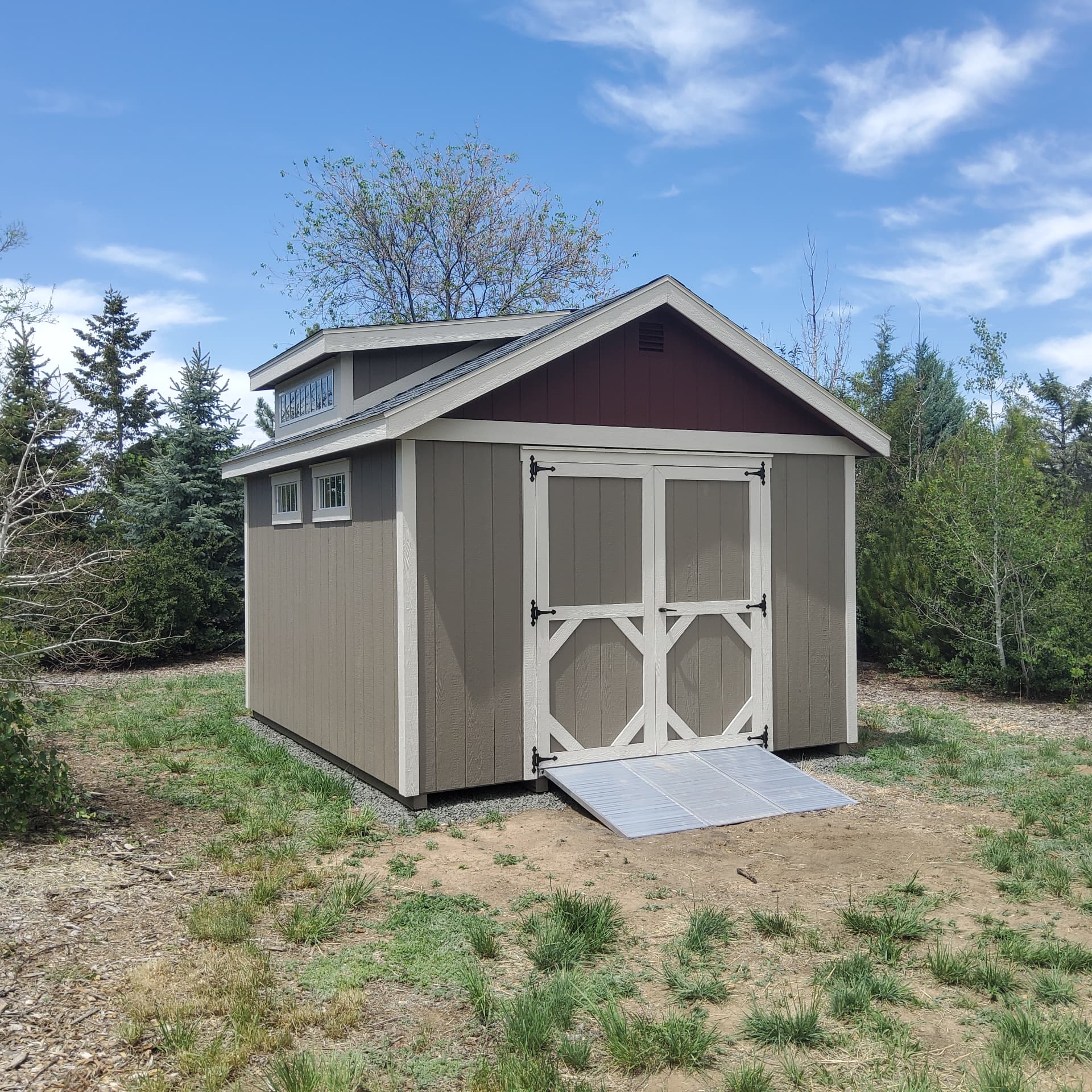 Colorado storage shed with wide double doors and a ramp for equipment access