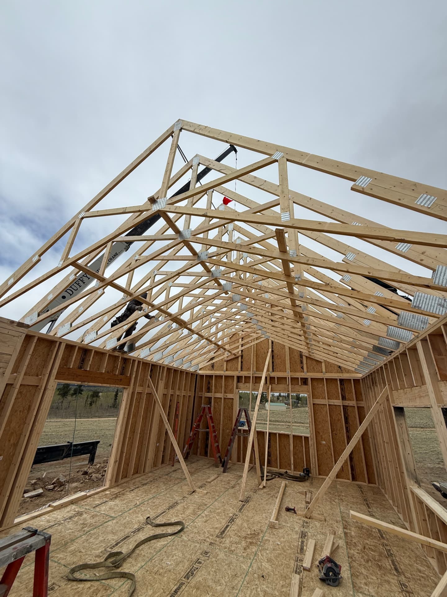 Engineered roof trusses being set on a Sunny Side home shell in Jefferson Colorado for heavy mountain snow load