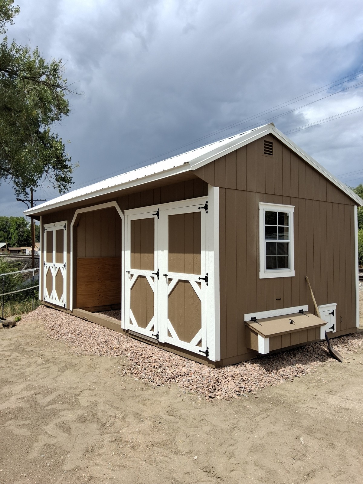 Loafing shed run-in horse shelter delivered to a rural Colorado pasture with mountain views