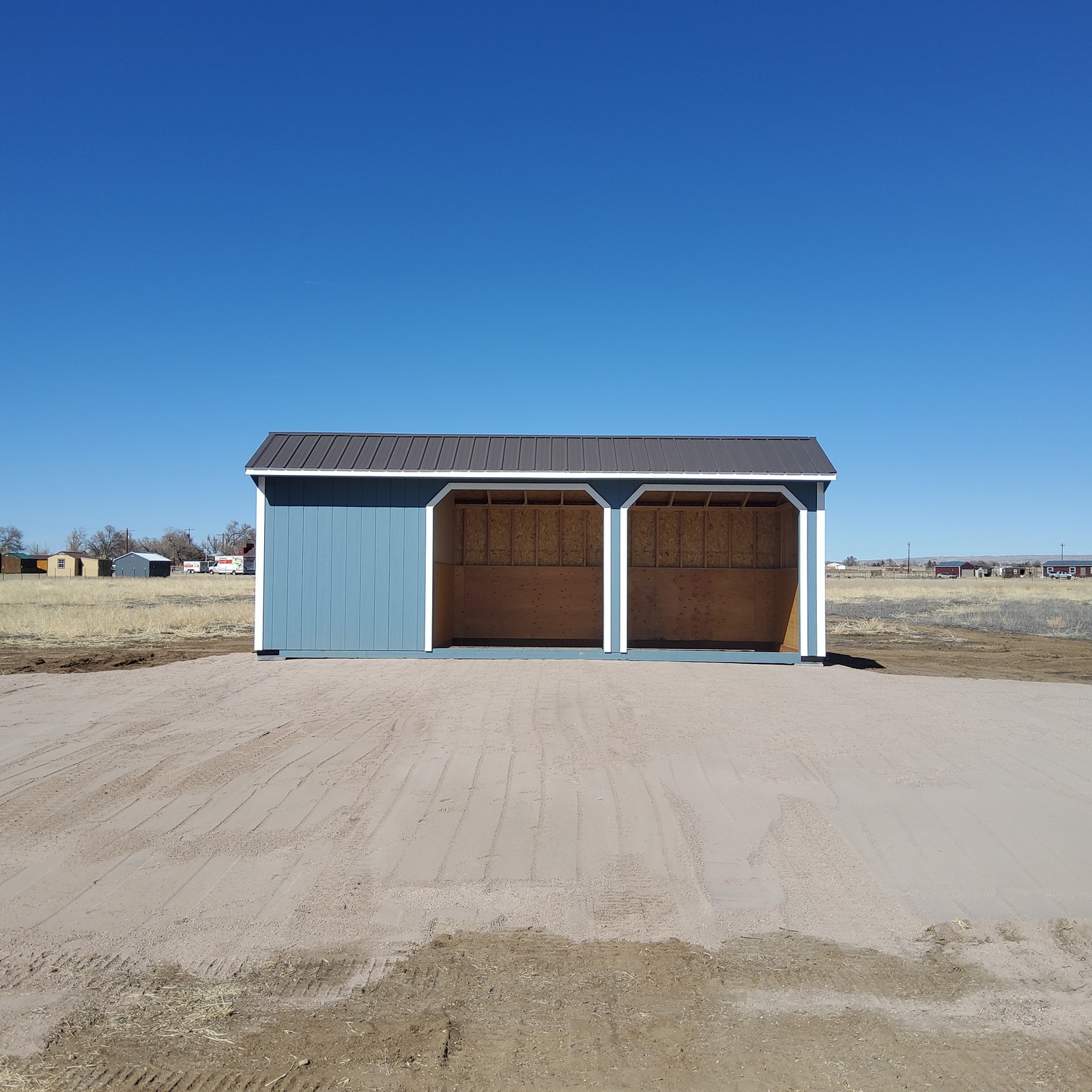 Loafing shed run-in horse shelter delivered to a fenced horse turnout in Colorado
