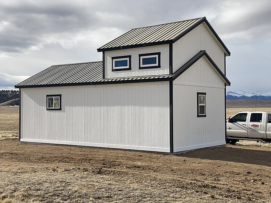 White Sunny Side shell with dormers and metal roof